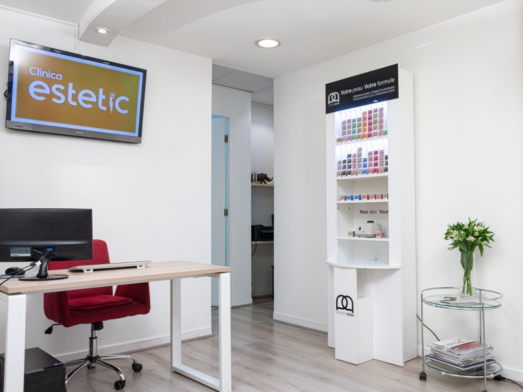 Recepción de Clínica Estetic, con el logotipo de la clínica y un mesón de atención